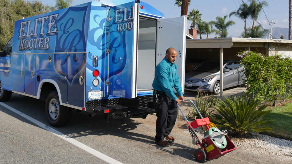 Elite Rooter crew unloading equipment at a job site